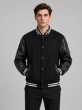 Men wearing black varsity jacket with leather sleeves and wool blend bomber style for fall winter