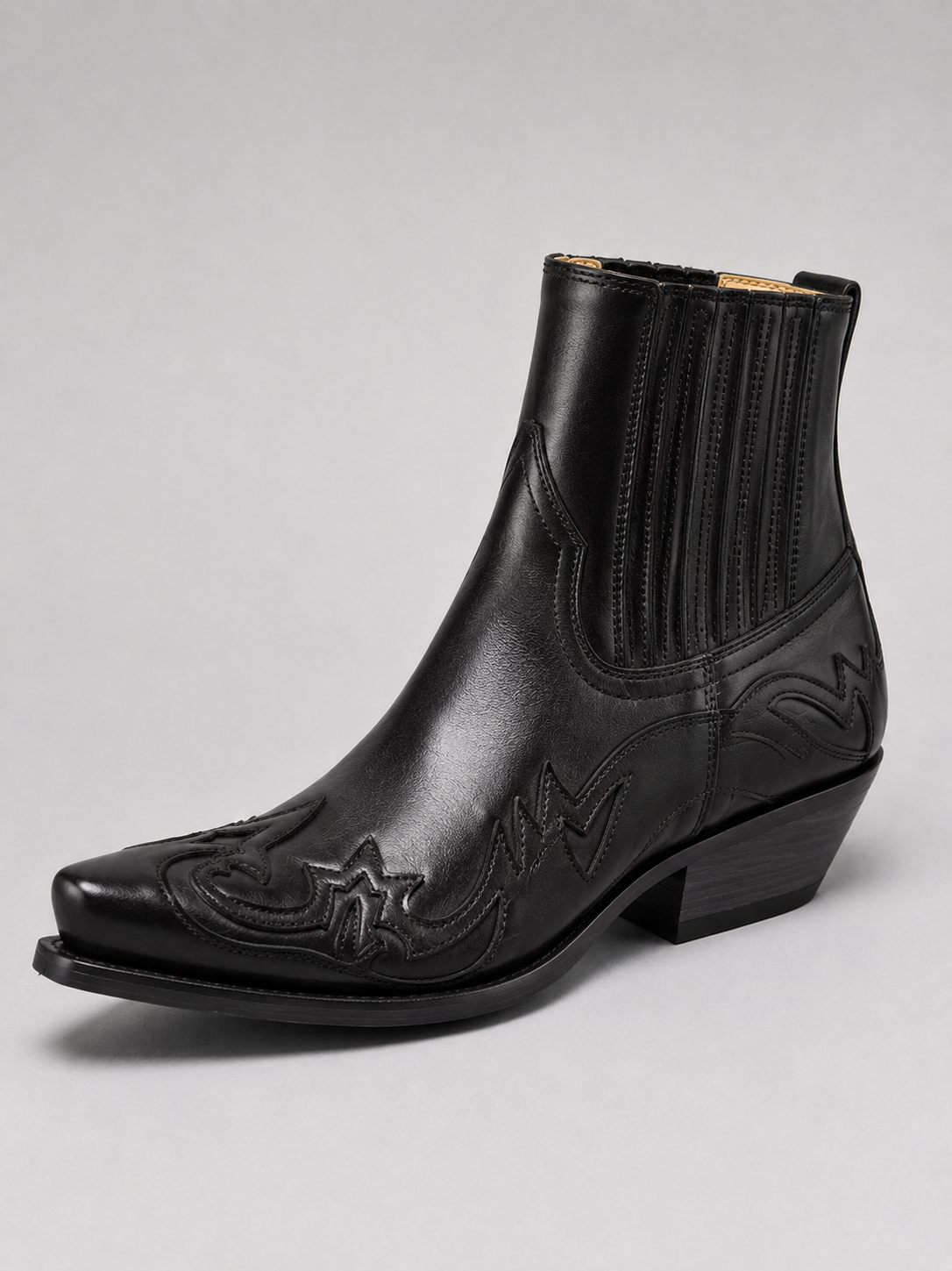 Angled view of black men’s western cowboy boots with embroidered leather, pointed toe, ankle height, and durable outsole