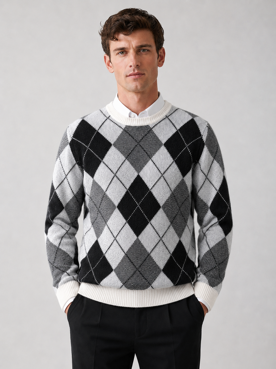 Front view of a man wearing a black wool argyle sweater with a crew neck, long sleeves, and thick warm knit construction