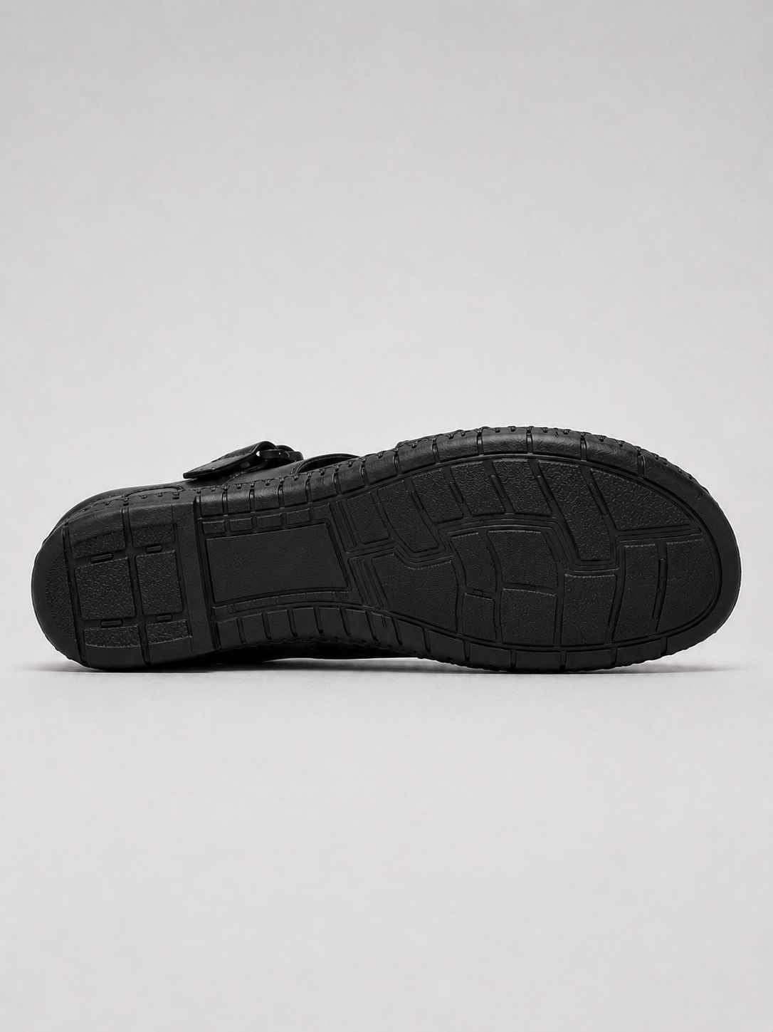 Black leather sandals in a relaxed summer beach and casual outdoor outfit