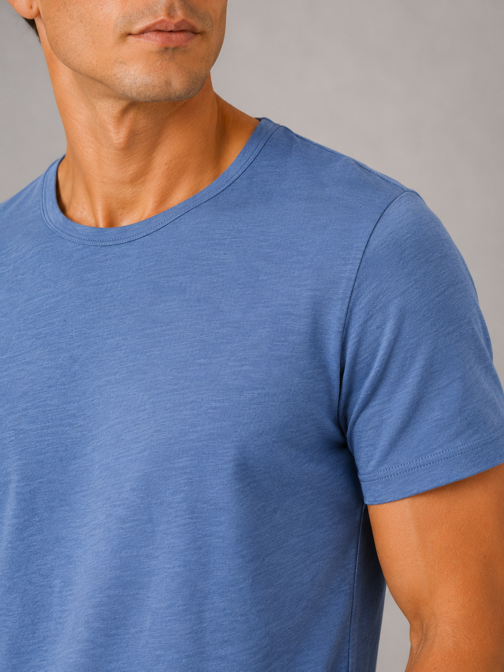 Close up of blue cotton t shirt showing soft breathable fabric and clean crew neck detail