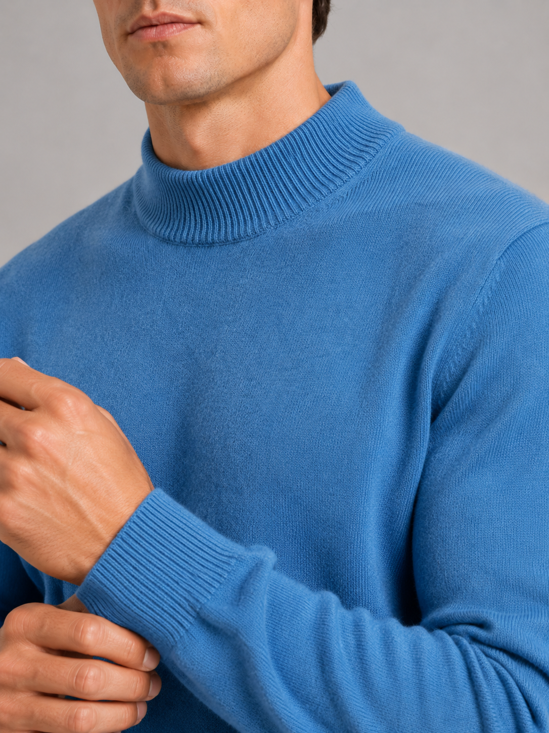 Close up of blue wool mock neck sweater showing soft premium knit texture and refined collar detail