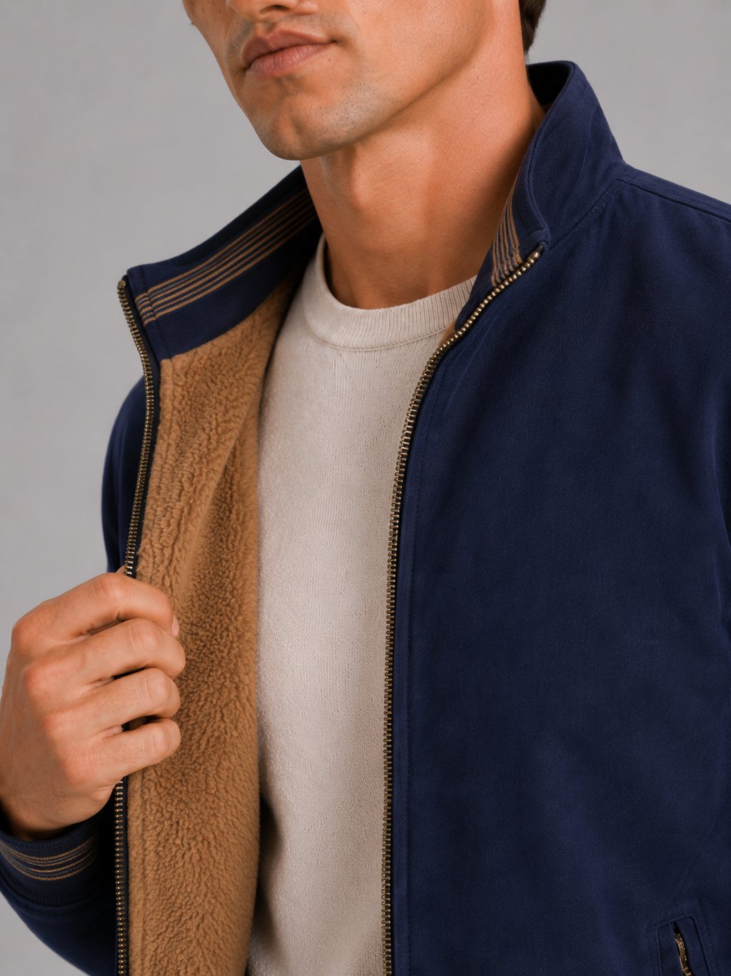 Close up of blue aviator jacket showing soft fleece lining and durable zipper detail