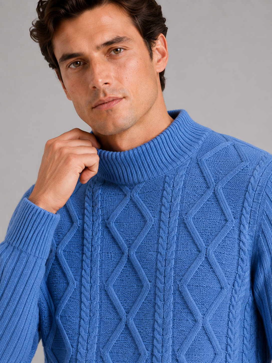 Close up of blue mock neck sweater showing jacquard twist cable knit texture and soft warm fabric