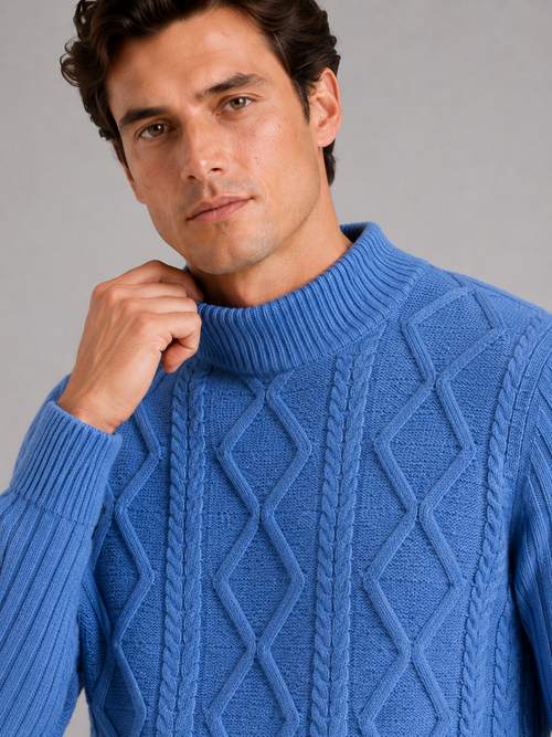 Close up of blue mock neck sweater showing jacquard twist cable knit texture and soft warm fabric