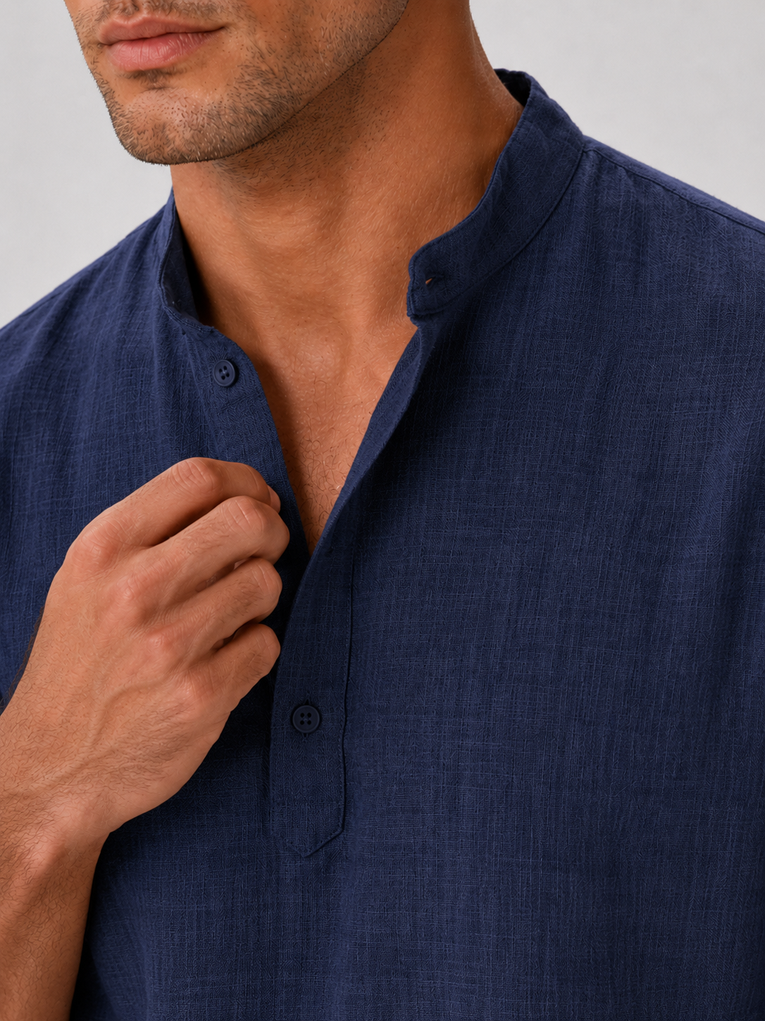 Close up of navy band collar shirt showing soft breathable fabric and button up detail