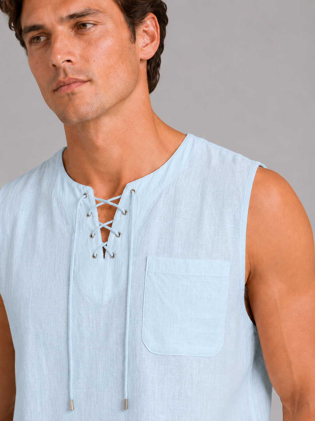 Close up of blue cotton linen tank top showing breathable fabric texture and lace up neckline detail