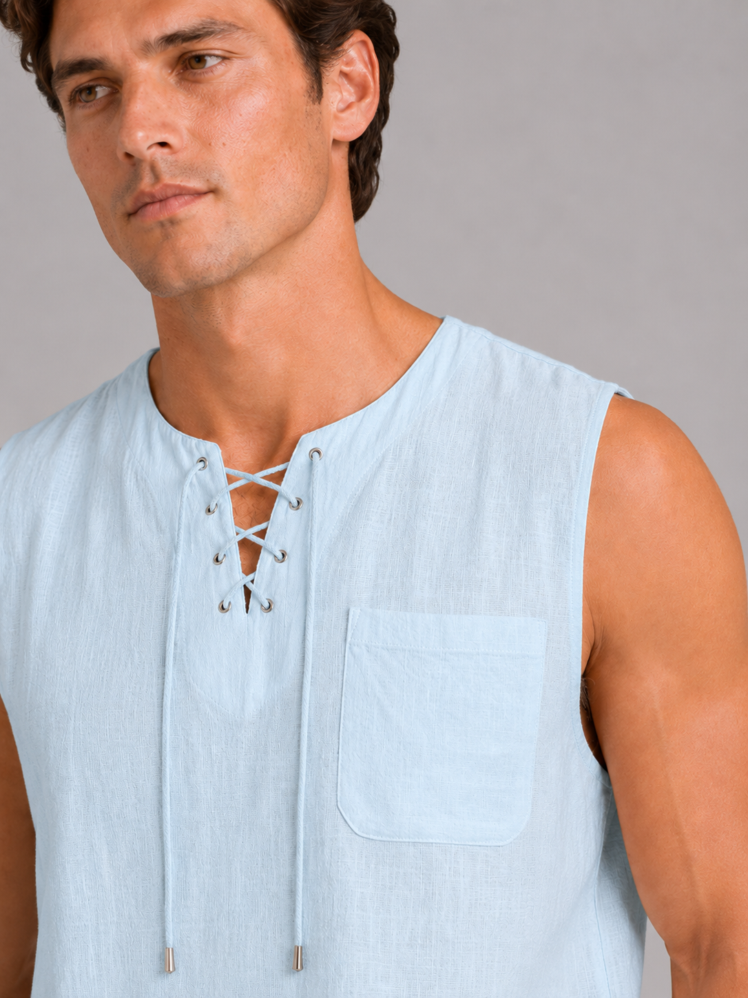 Close up of blue cotton linen tank top showing breathable fabric texture and lace up neckline detail