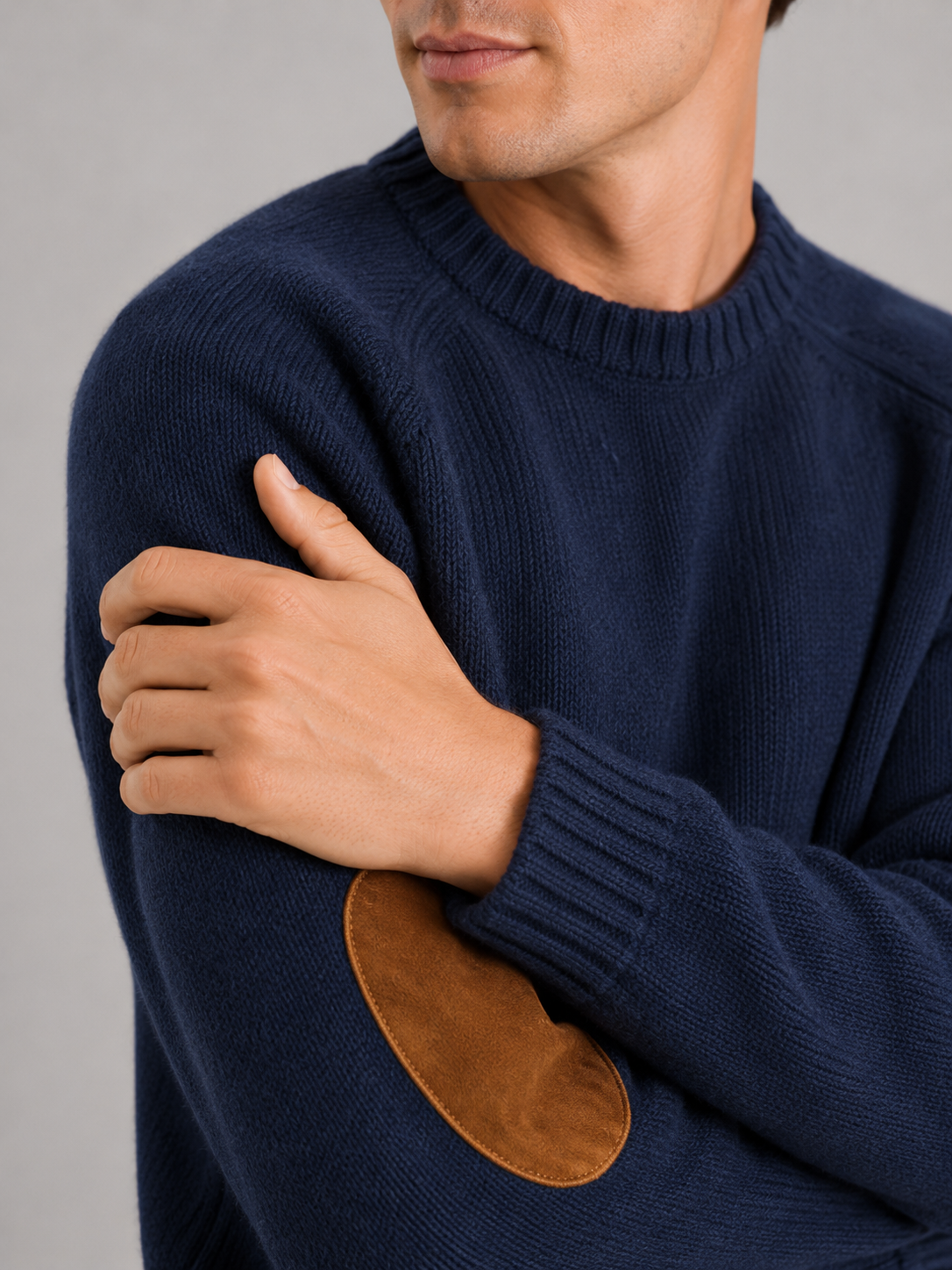 Close up of blue wool knit sweater showing thick warm texture and clean crew neck detail