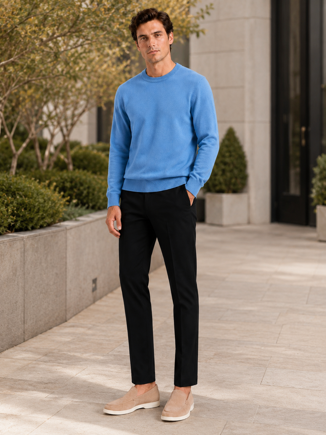 Man styling blue crewneck sweater in a relaxed everyday fall winter lifestyle outfit