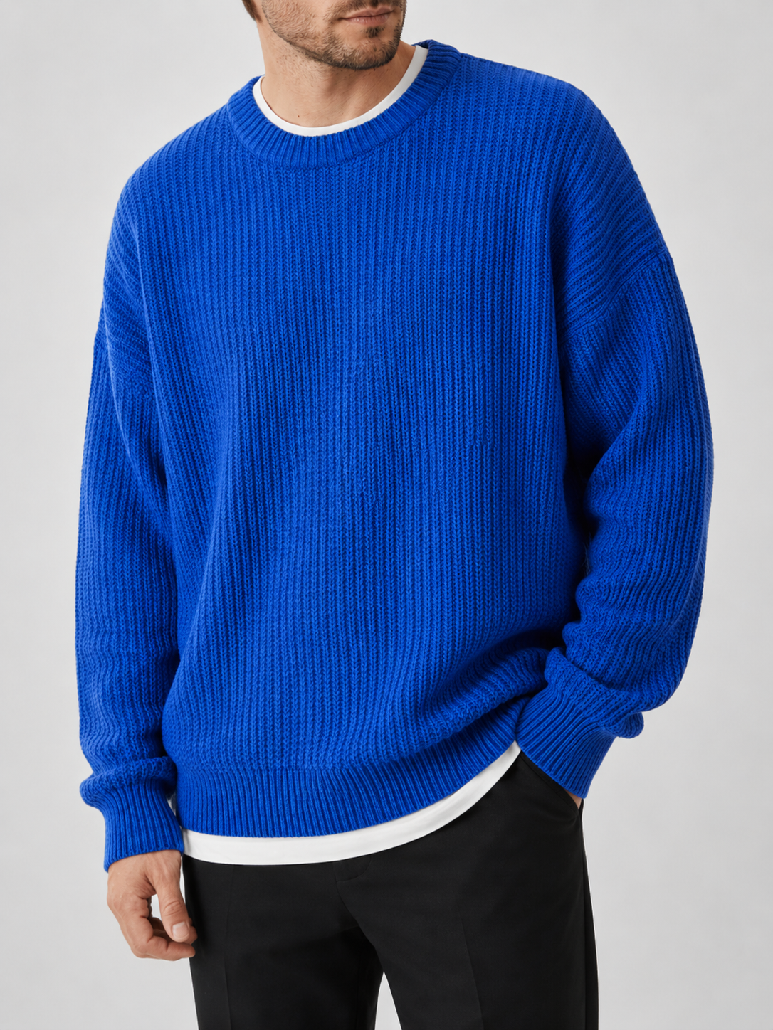 Close up of blue crewneck sweater showing soft knit texture and classic ribbed neckline detail