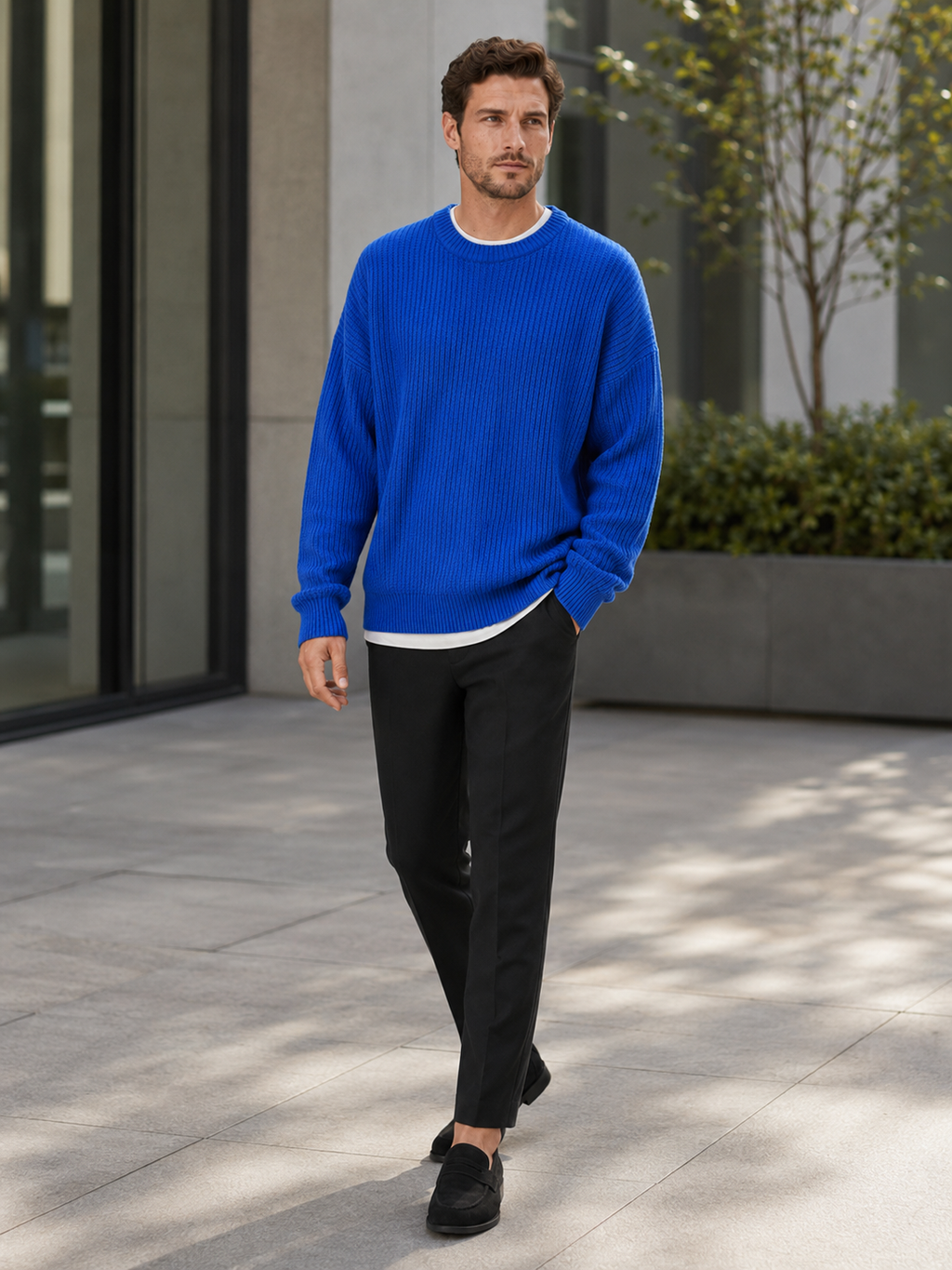 Man styling blue crewneck sweater in a polished everyday fall lifestyle outfit
