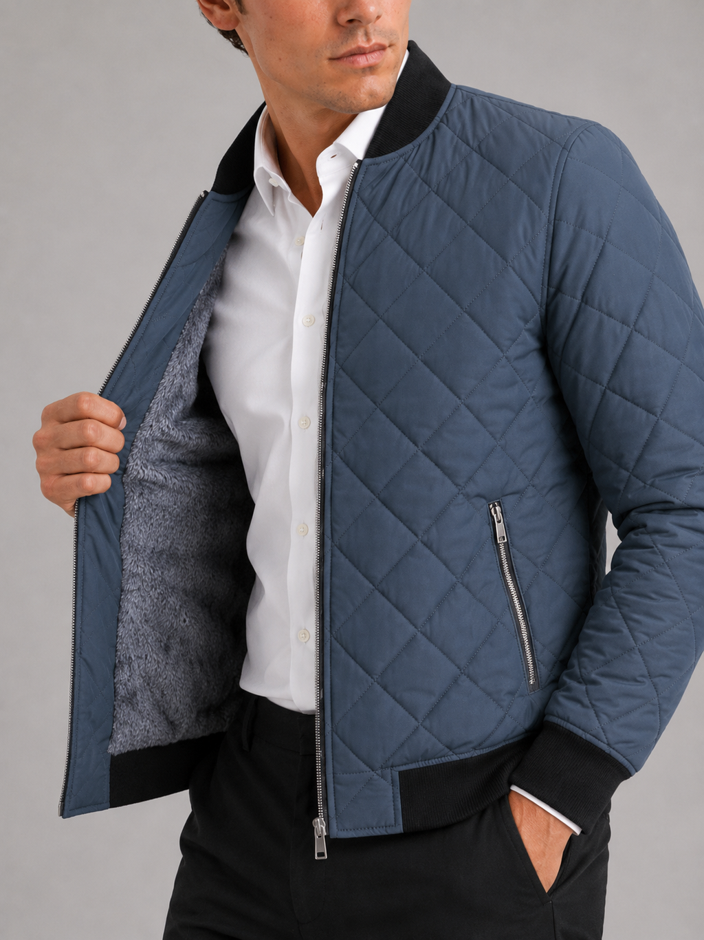 Close up of blue diamond pattern bomber jacket showing fleece lining and textured fabric detail