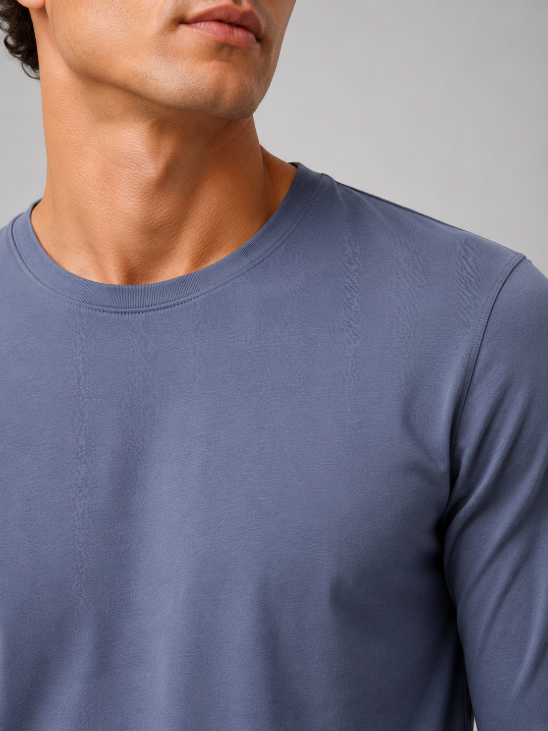 Close up of pastel blue t shirt fabric showing soft smooth breathable texture