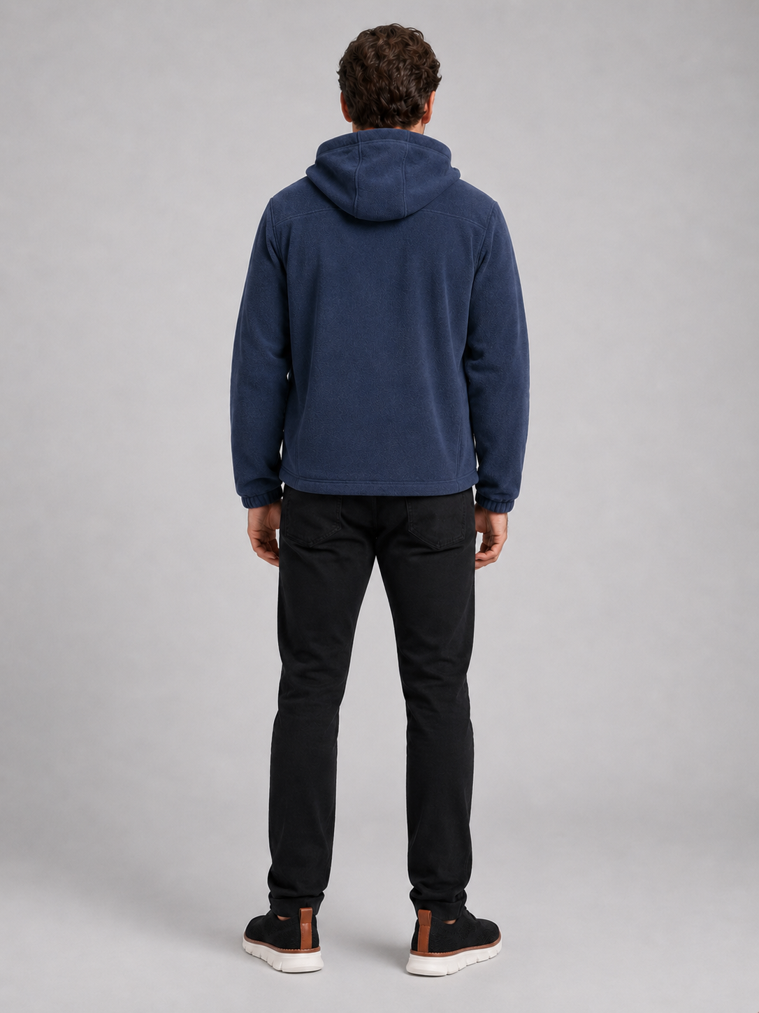 Back view of a man wearing a blue hooded fleece jacket showing the attached hood, thick fleece construction, long sleeves, and comfortable outdoor fit