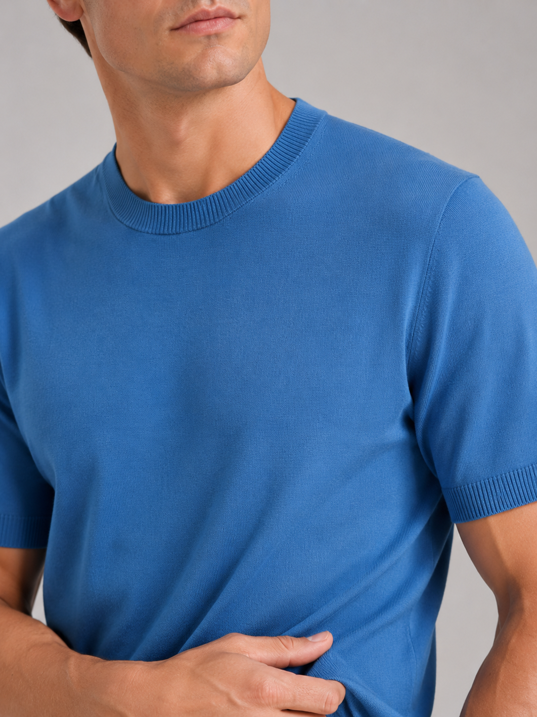 Close up of blue merino wool knit t shirt showing soft breathable texture and crew neck detail