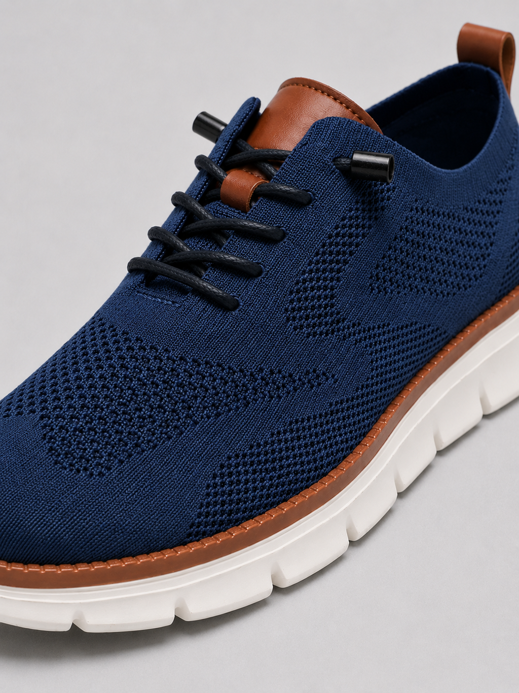 Close up of blue mesh sneakers showing breathable knit upper and cushioned sole detail