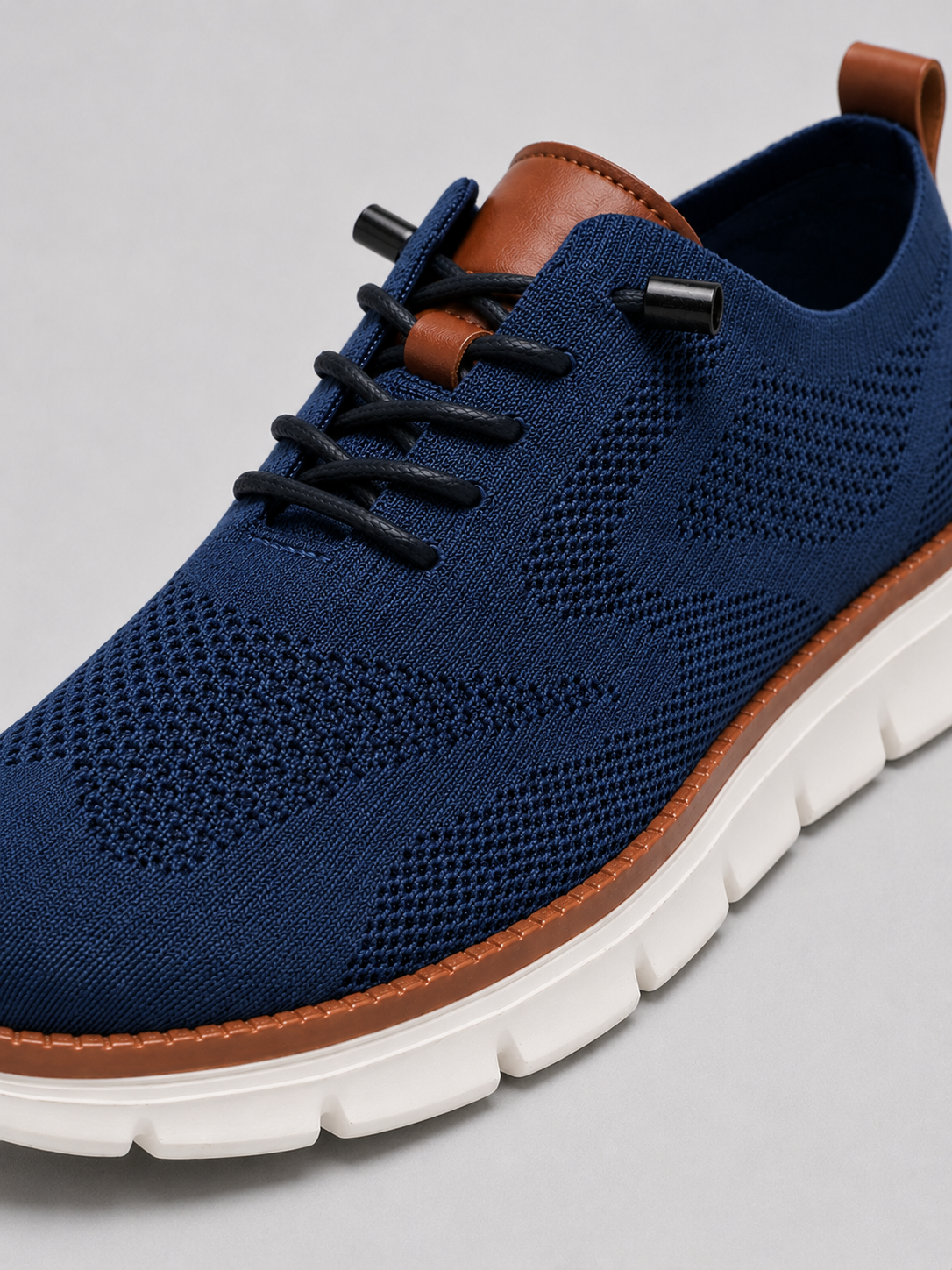 Close up of blue mesh sneakers showing breathable knit upper and cushioned sole detail