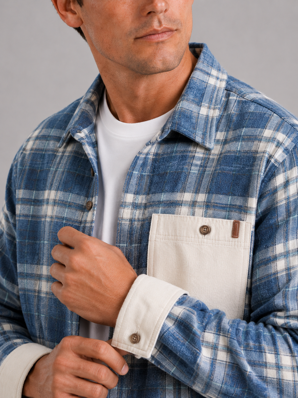 Close up of blue plaid flannel shacket showing soft brushed fabric and chest pocket detail