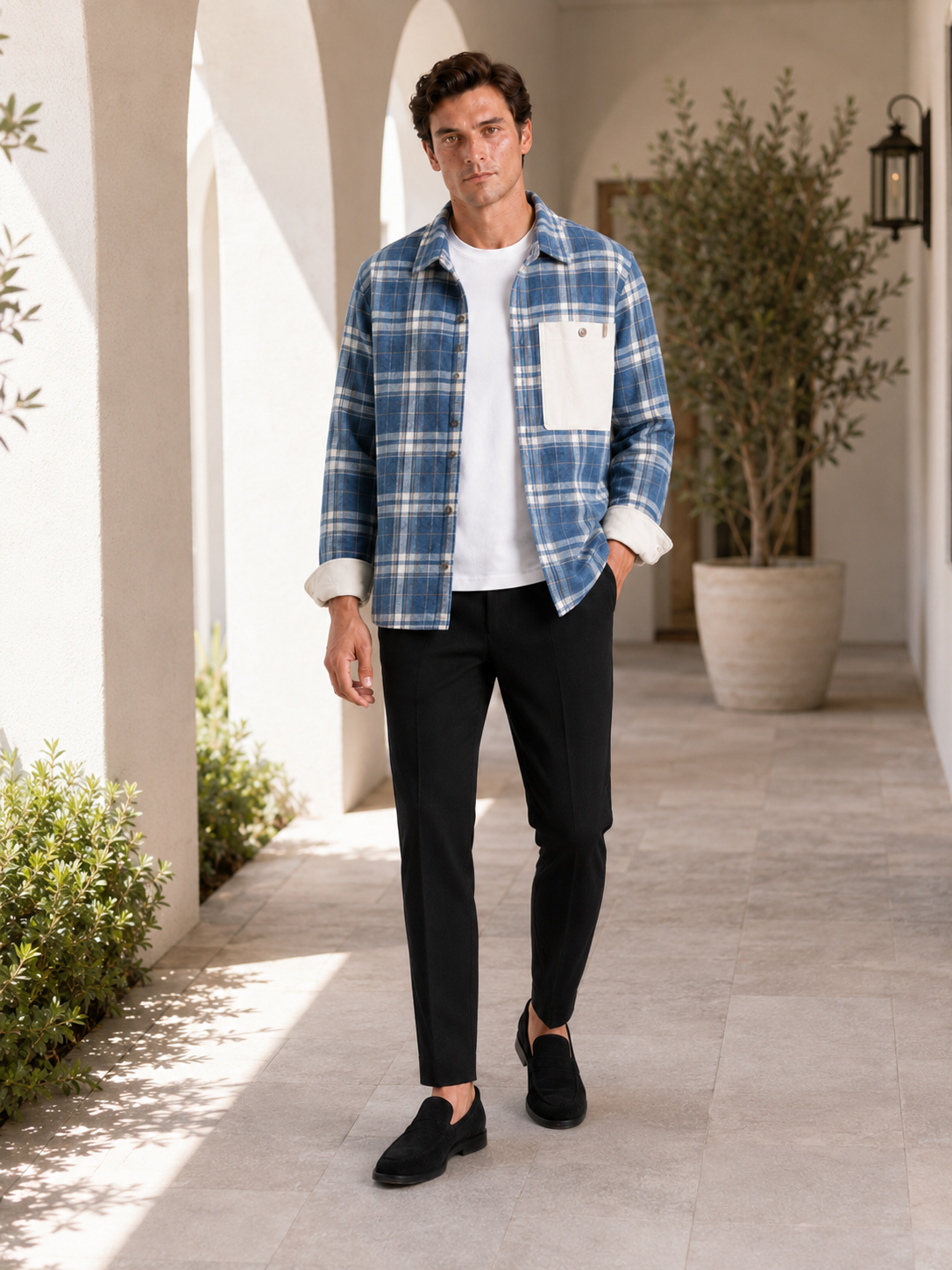 Man styling blue plaid flannel shirt jacket in a rugged outdoor and everyday lifestyle outfit