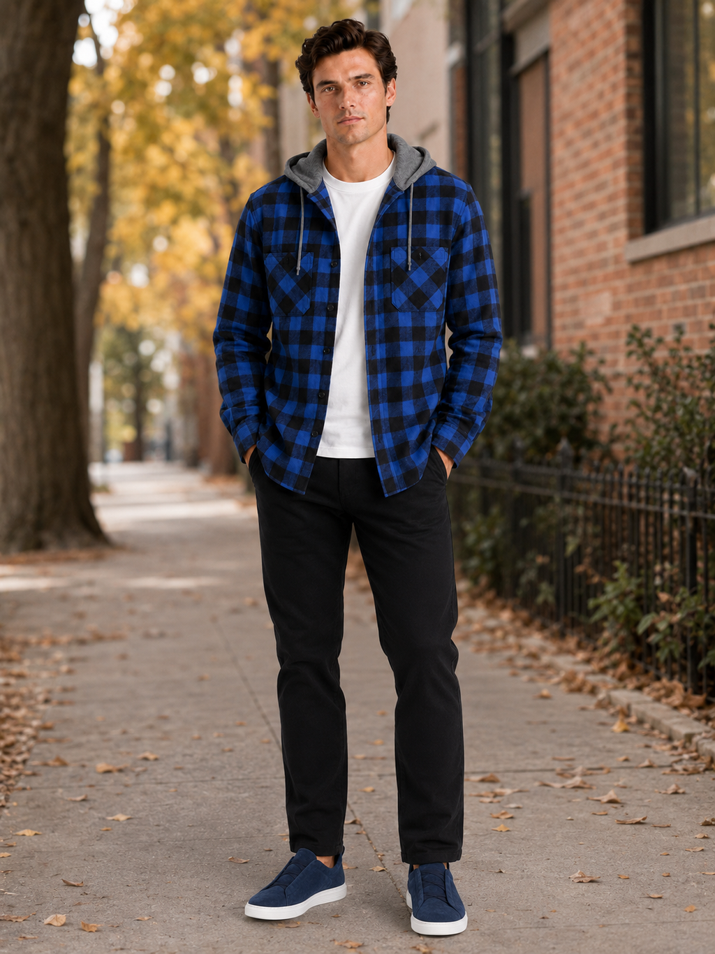 Man styling blue plaid hooded flannel jacket in a modern fall streetwear lifestyle outfit