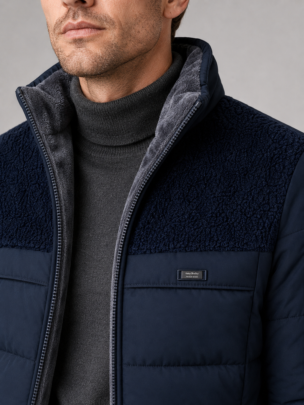 Close up of blue puffer jacket showing plush lining, insulated quilting, and stand collar detail