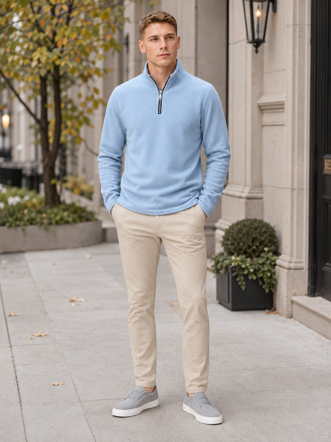 Man styling blue quarter zip fleece sweater in a rugged outdoor and winter lifestyle outfit