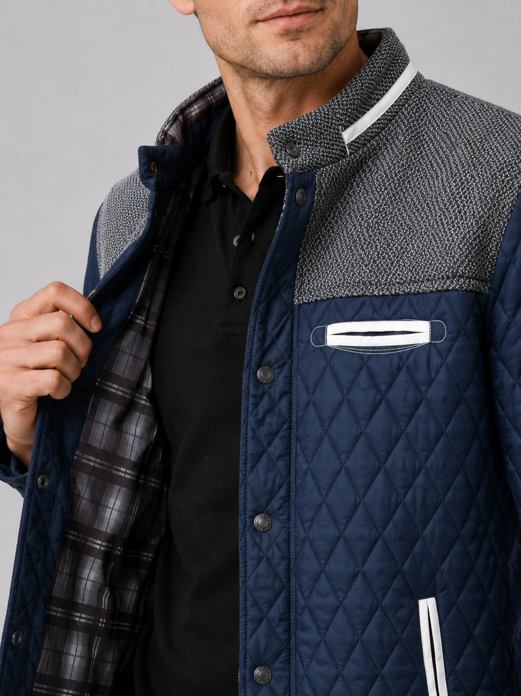 Close up of blue quilted jacket showing diamond stitching and button down front detail