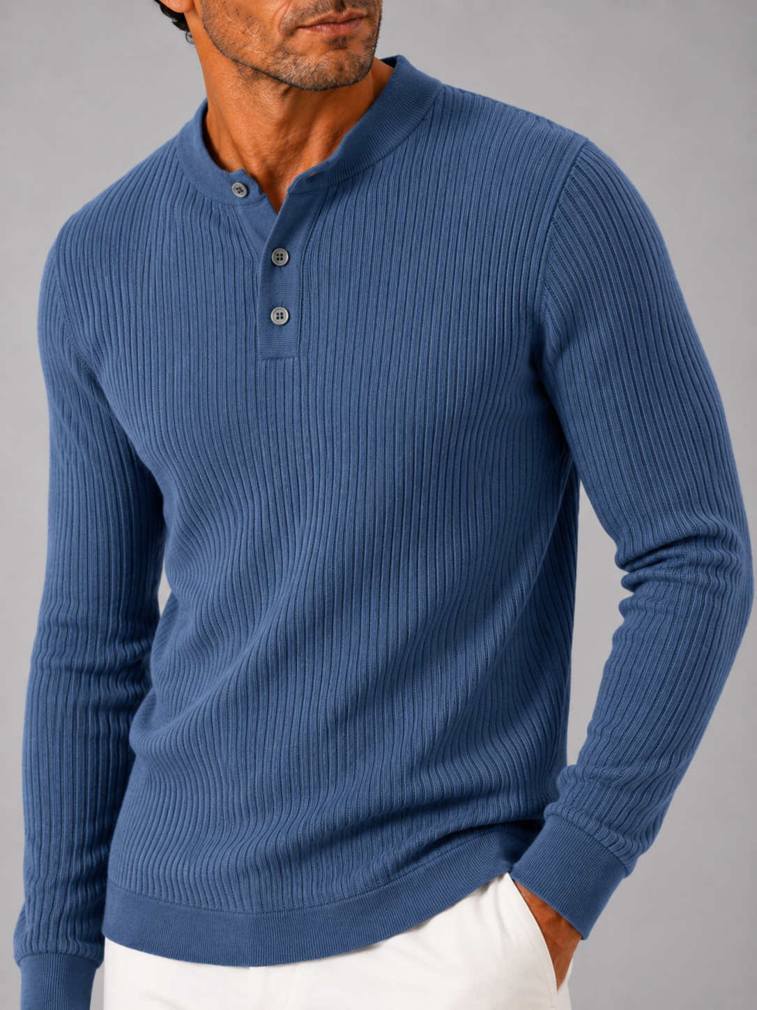 Close up of blue ribbed henley polo showing striped knit texture and button detail