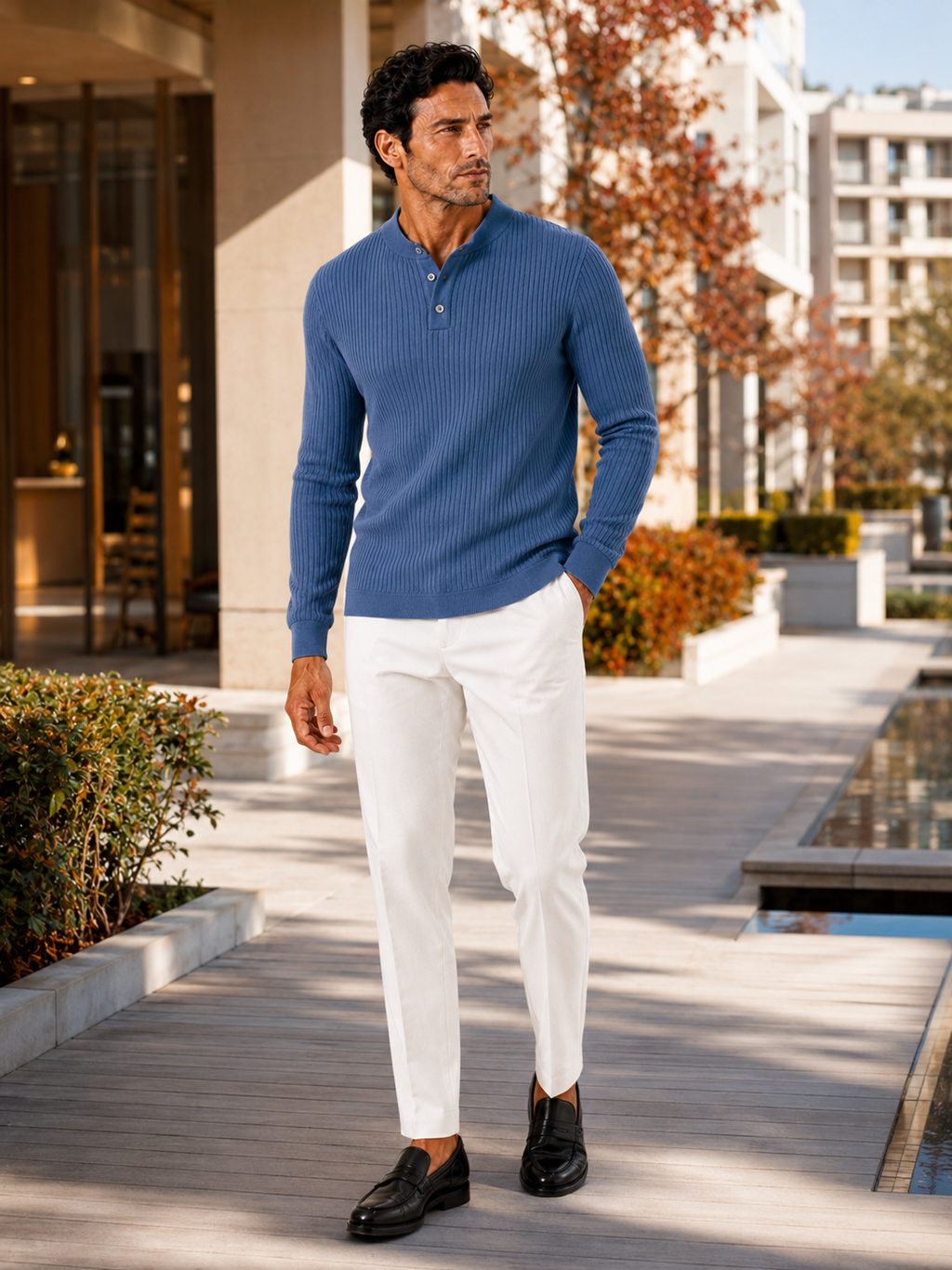 Man styling blue henley polo shirt in a clean autumn business casual outfit