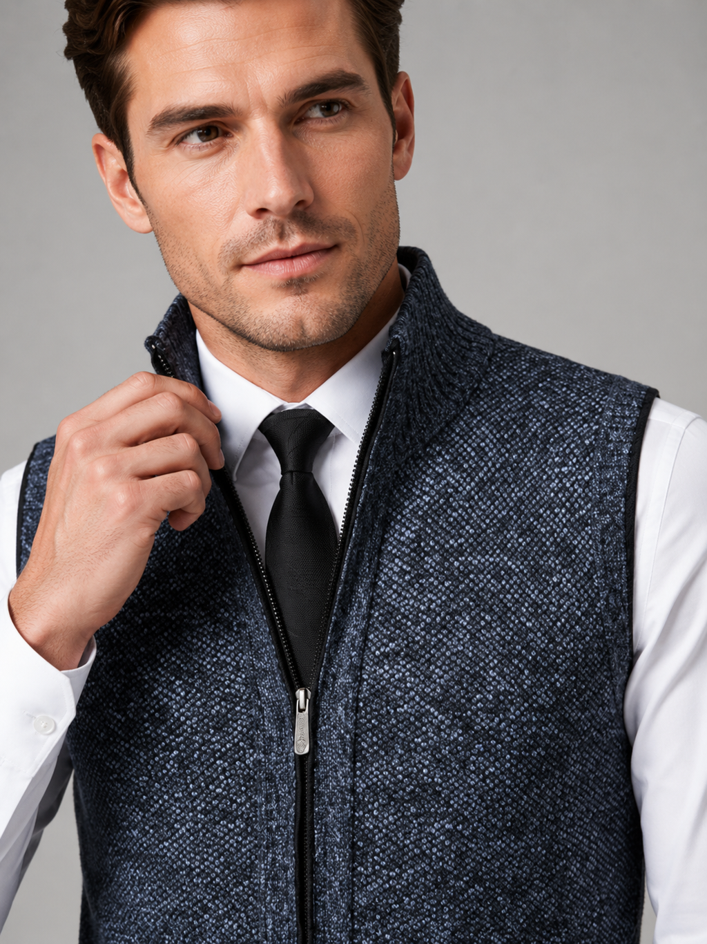 Close up of blue full zip sweater vest showing soft knit texture and stand collar zipper detail