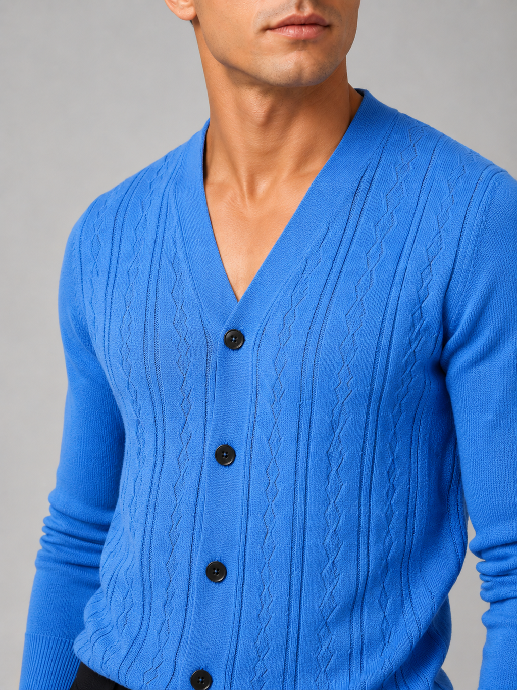 Close up of blue knit cardigan showing soft lightweight texture and refined button front detail