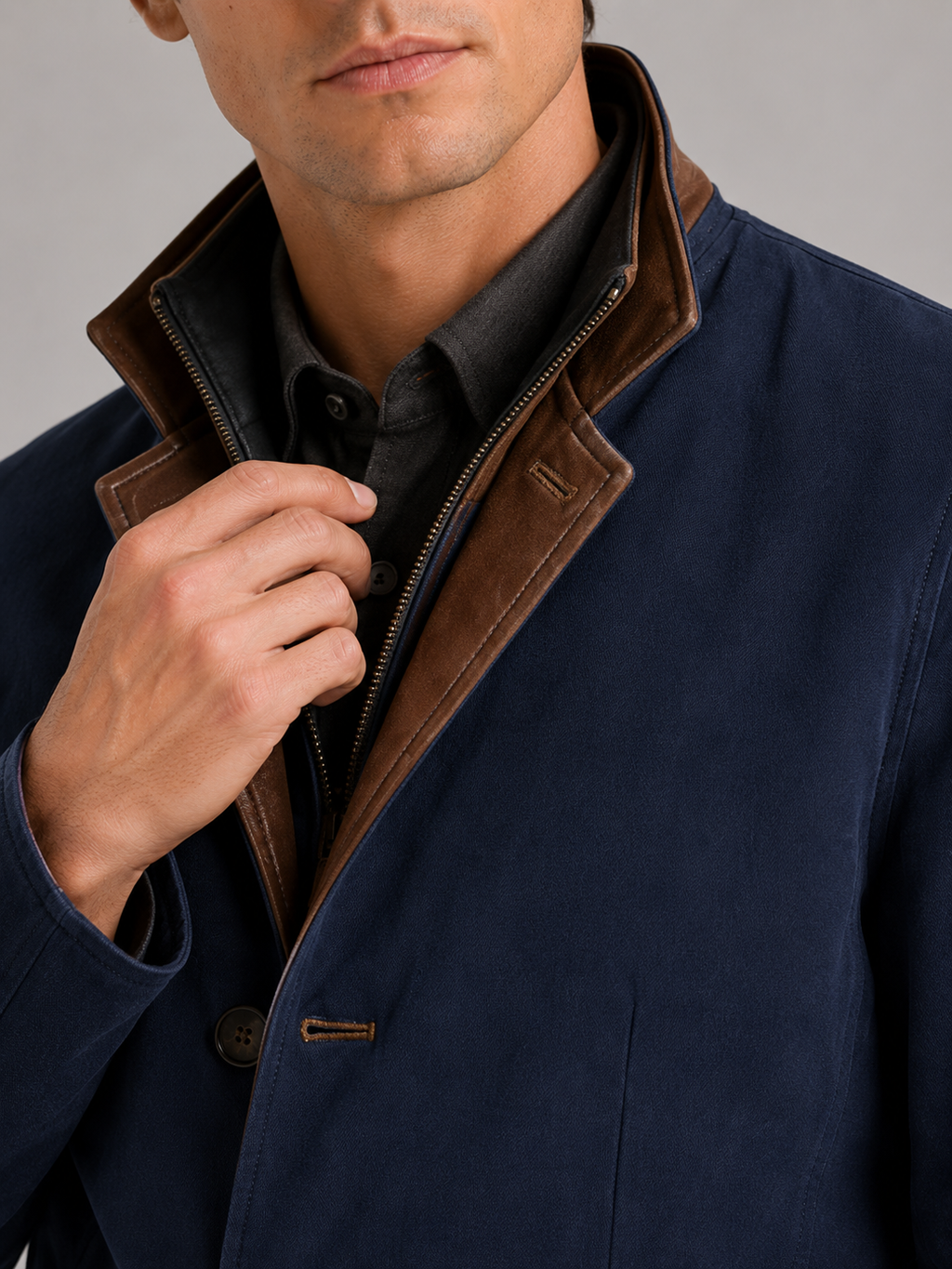 Close up of blue workwear jacket showing contrast color details and durable fabric texture