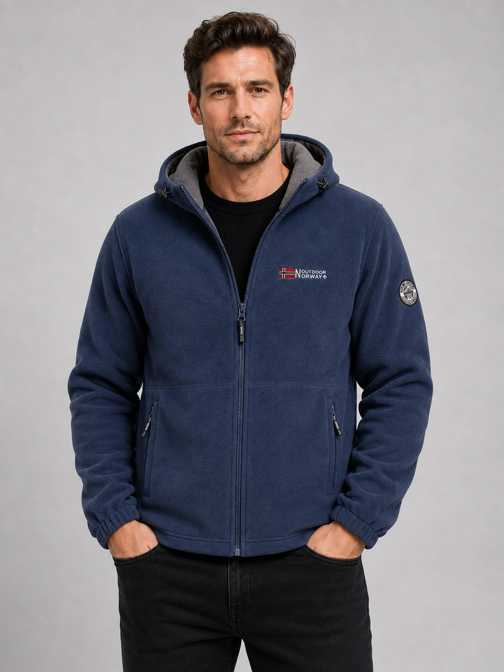 Front view of a man wearing a blue hooded fleece jacket with a windproof design, thick warm construction, and full zip front