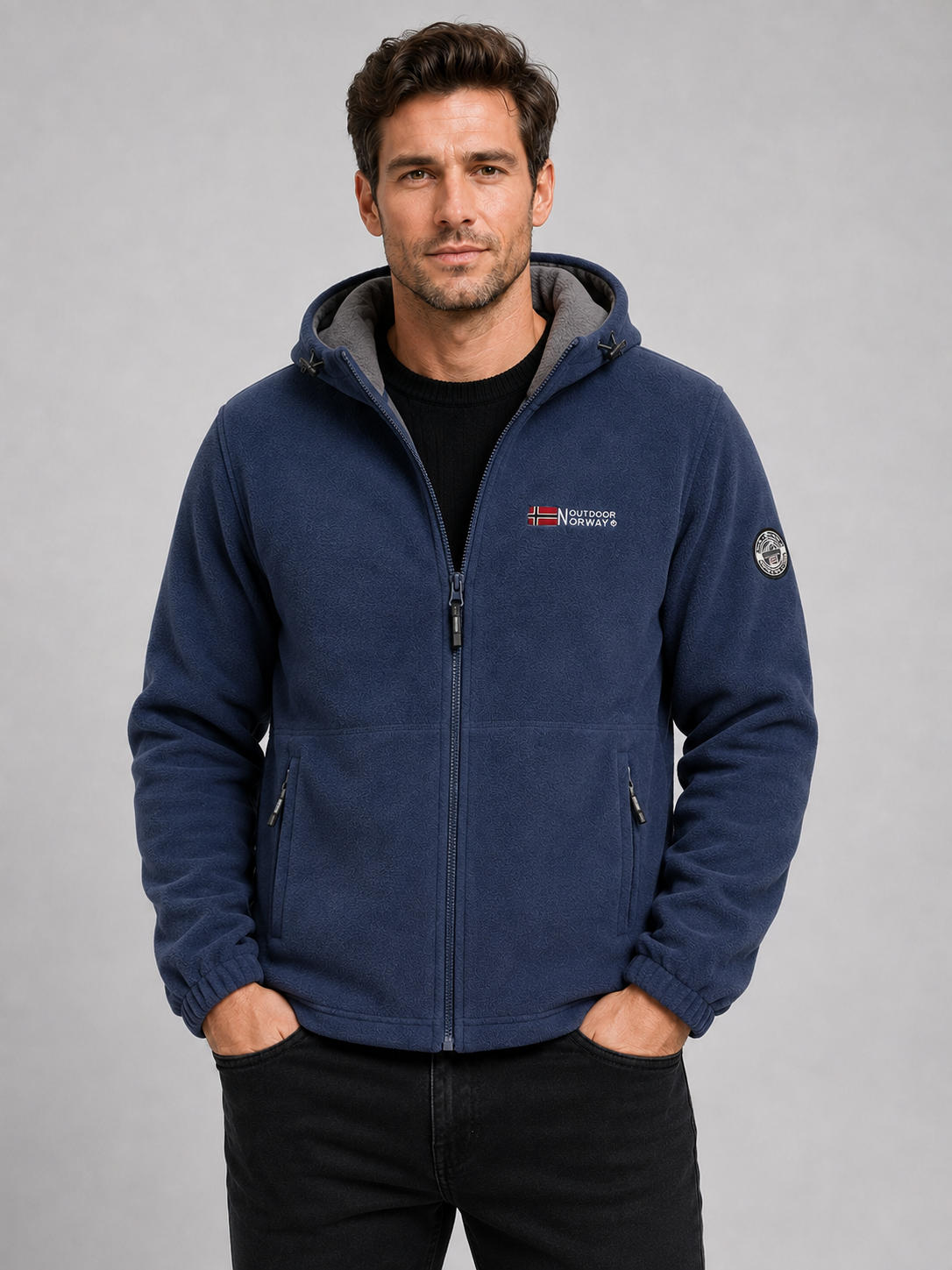 Front view of a man wearing a blue hooded fleece jacket with a windproof design, thick warm construction, and full zip front