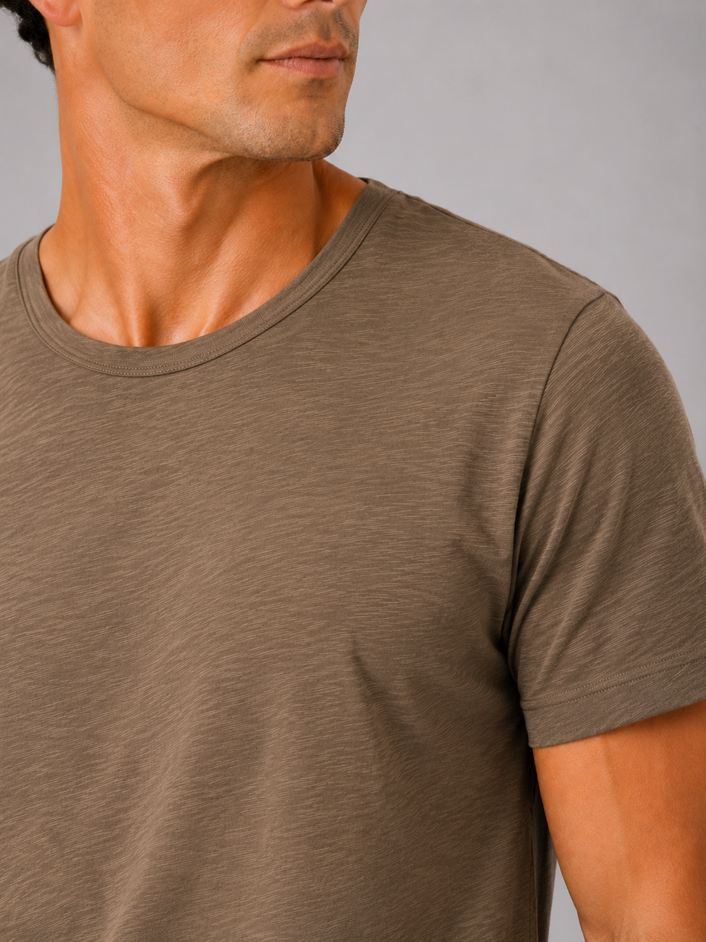Close up of brown cotton t shirt showing soft breathable fabric and clean crew neck detail