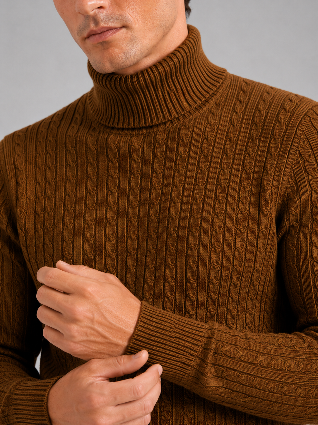 Close up of brown cable knit turtleneck showing thick textured fabric and warm collar detail