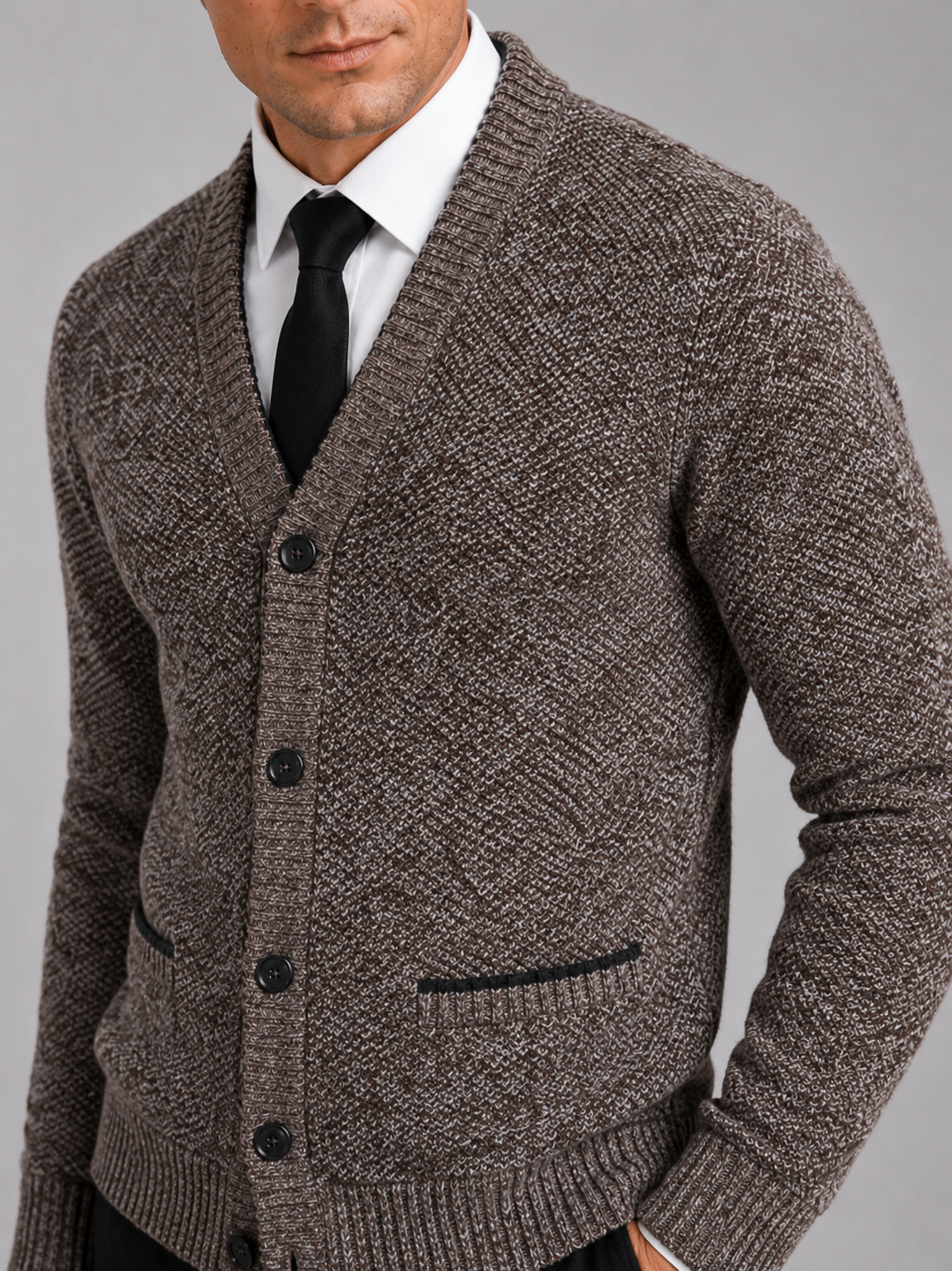 Close up of brown knit cardigan showing soft textured fabric and refined button front detail
