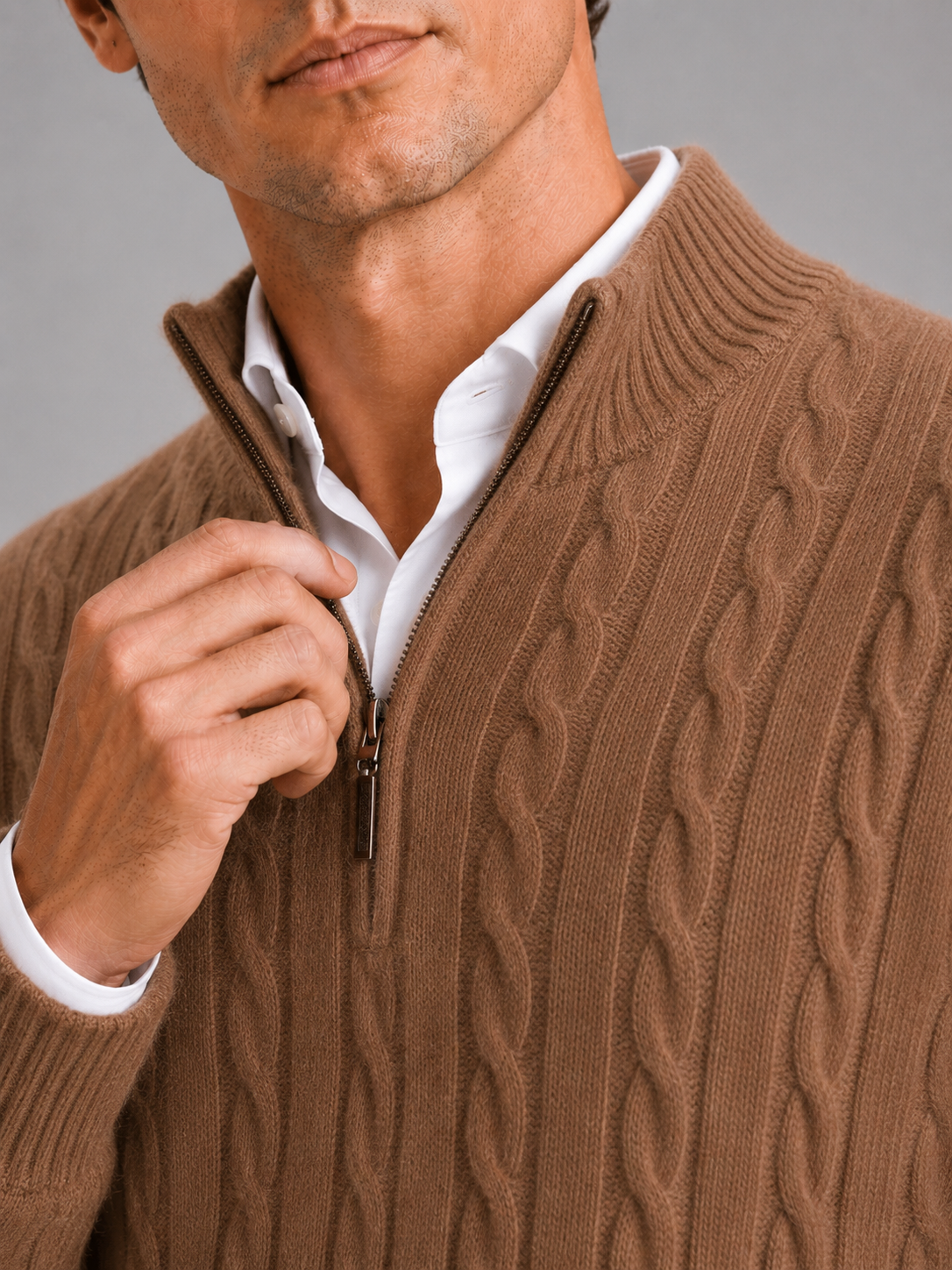 Close up of brown cashmere sweater showing soft cable knit texture and quarter zip detail