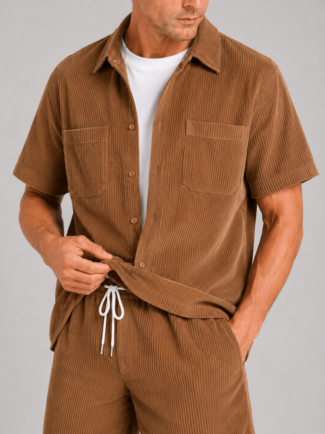 Close up of brown corduroy two piece set showing soft textured fabric and button up shirt detail