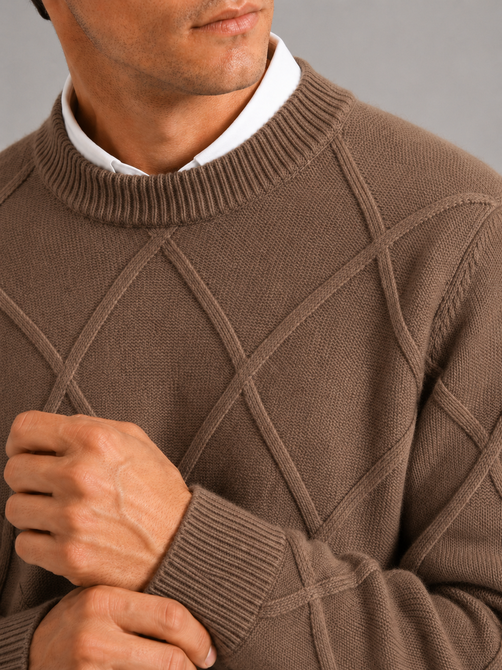 Close up of brown cable knit sweater showing soft fleece texture and thick woven detail