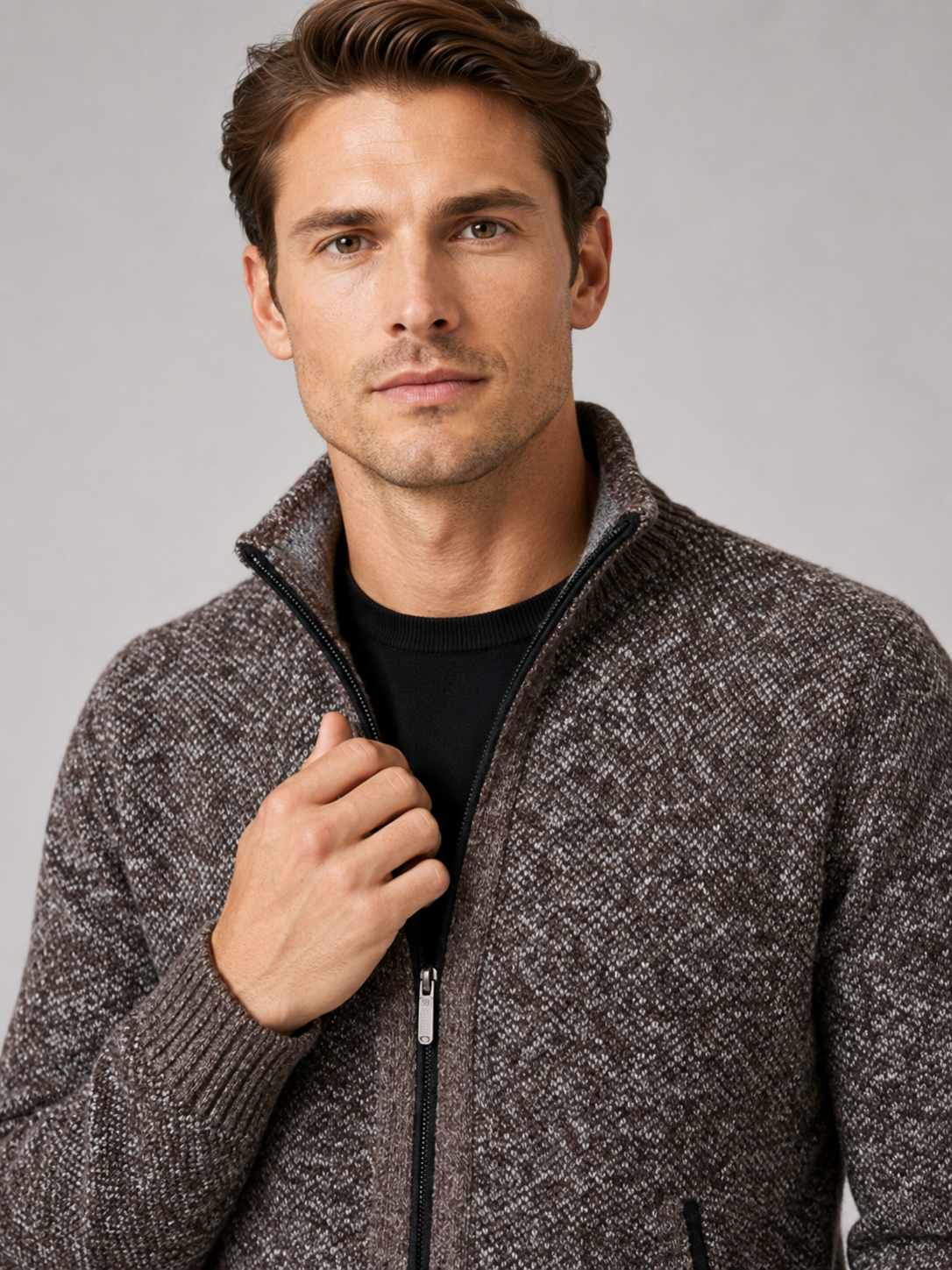 Close up of brown fleece cardigan showing soft knit texture, full zip front, and warm fleece lining detail