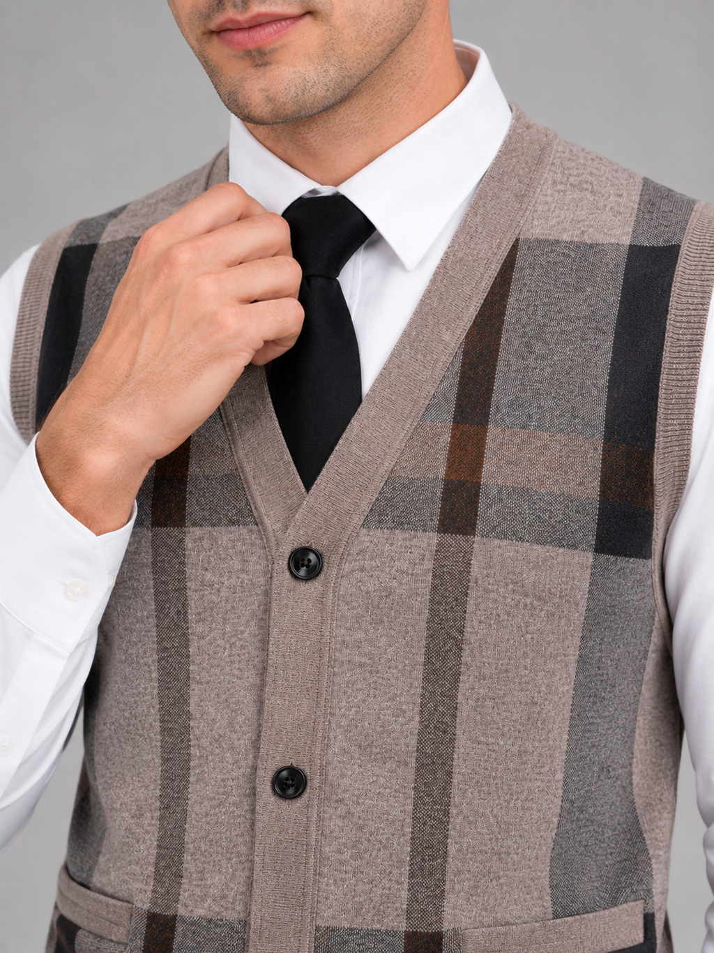 Close up of brown fleece sweater vest showing soft knit texture and button front detail
