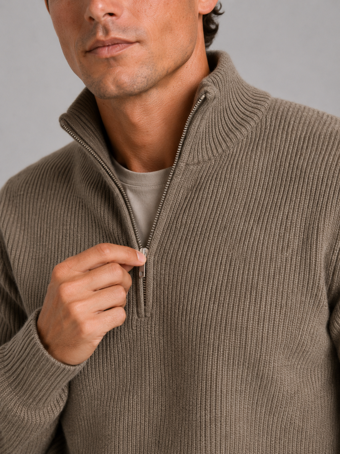 Close up of brown half zip sweater showing thick knit texture and refined zipper detail