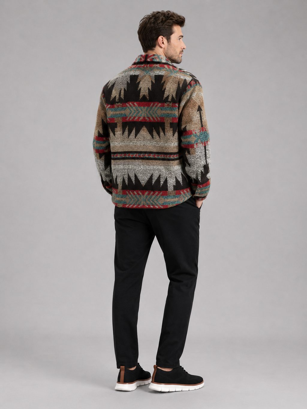 Back view of a man wearing a brown flannel shirt jacket showing the ethnic print, relaxed fit, long sleeves, and heavyweight wool blend fabric