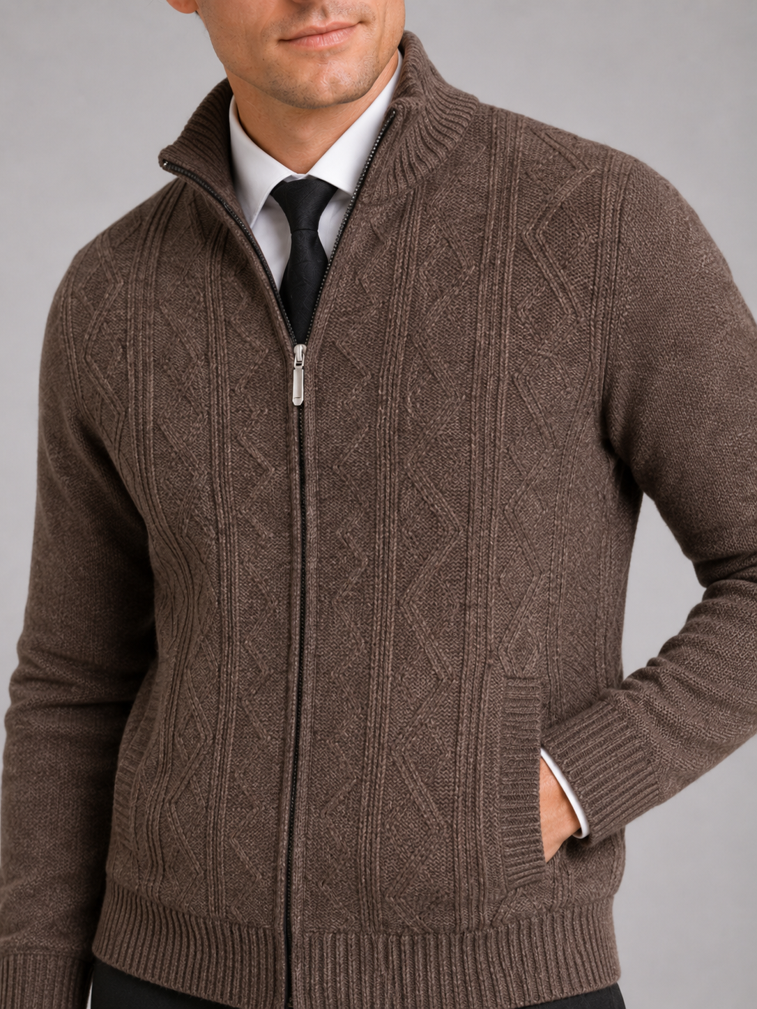 Close up of brown full zip sweater showing thick knit texture and stand collar detail