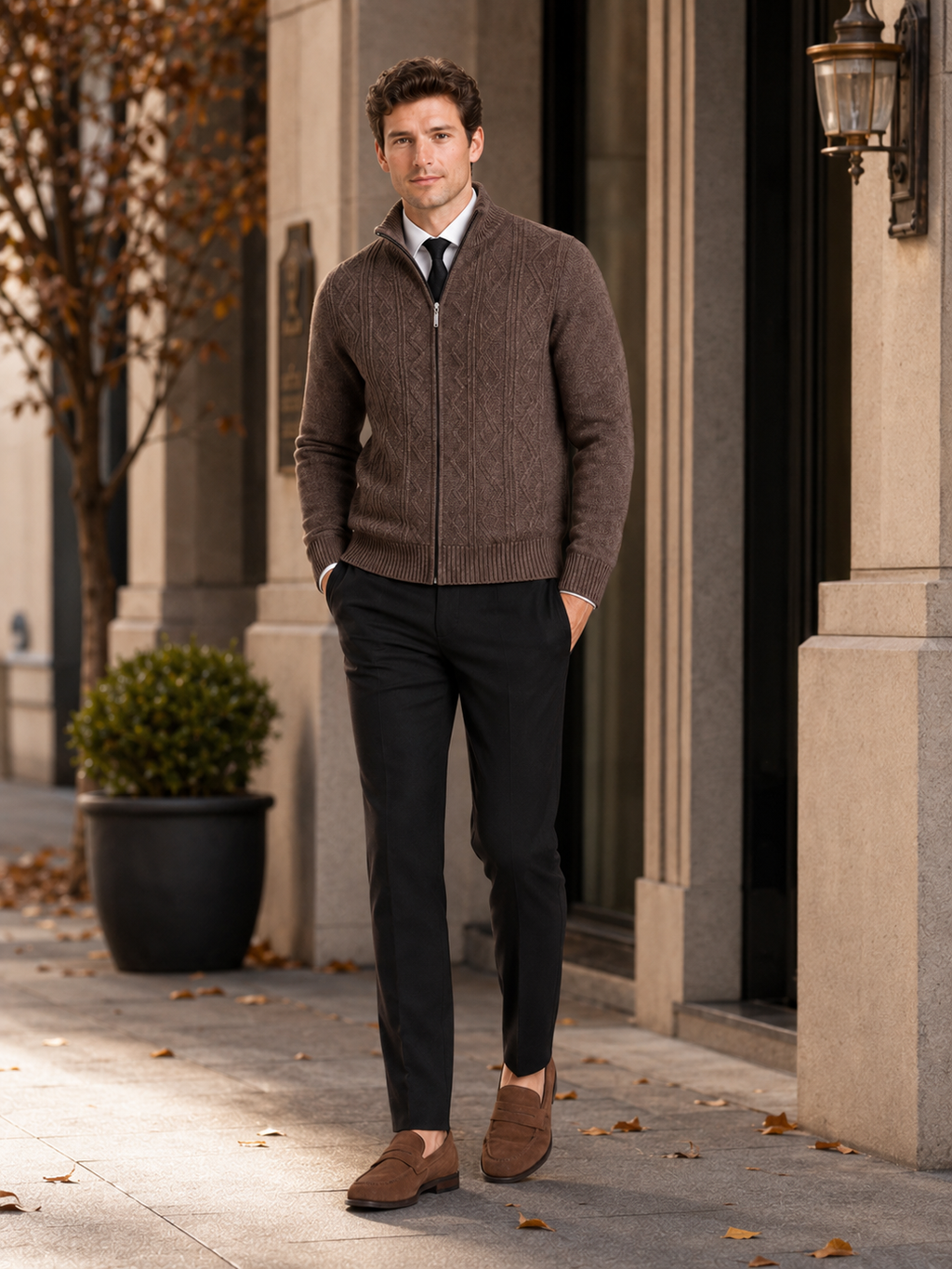 Man styling brown full zip knit sweater in a warm fall winter everyday outfit