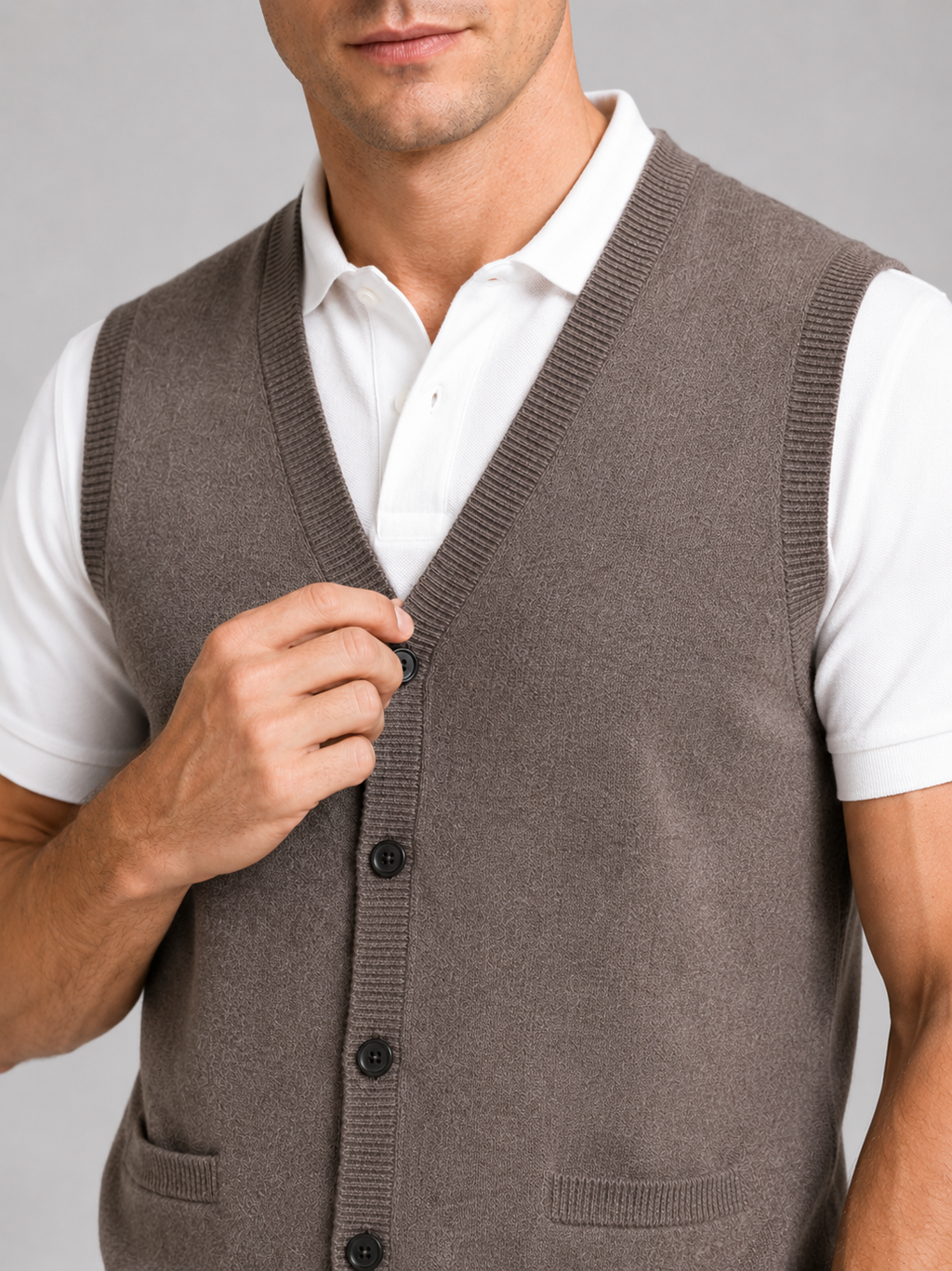 Close up of brown button up sweater vest showing soft knit texture and classic v neck detail