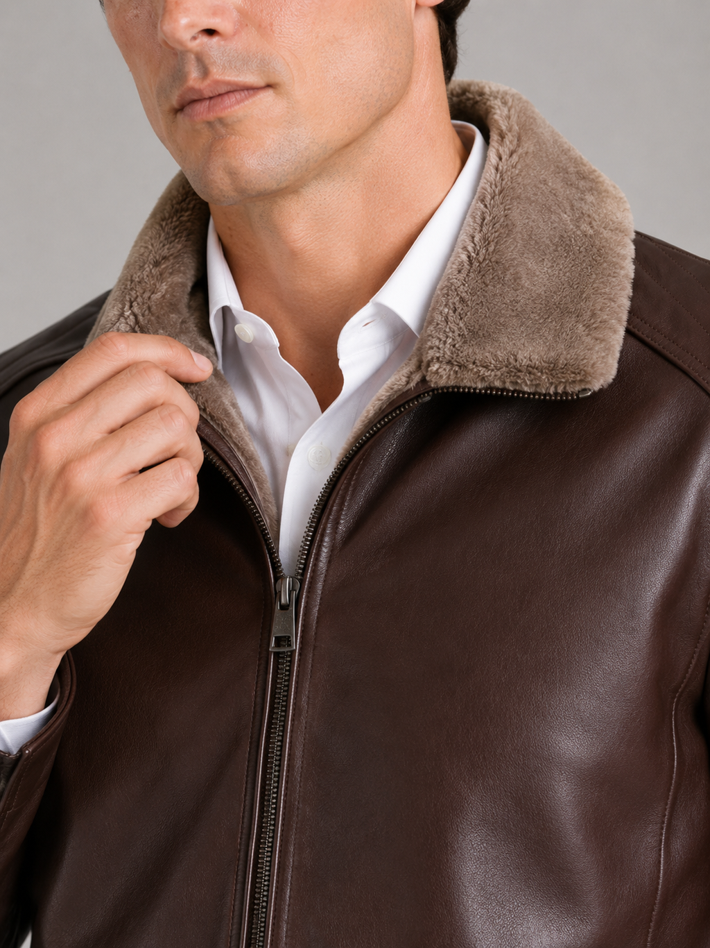 Close up of brown leather biker jacket showing smooth leather texture and soft fleece lining detail