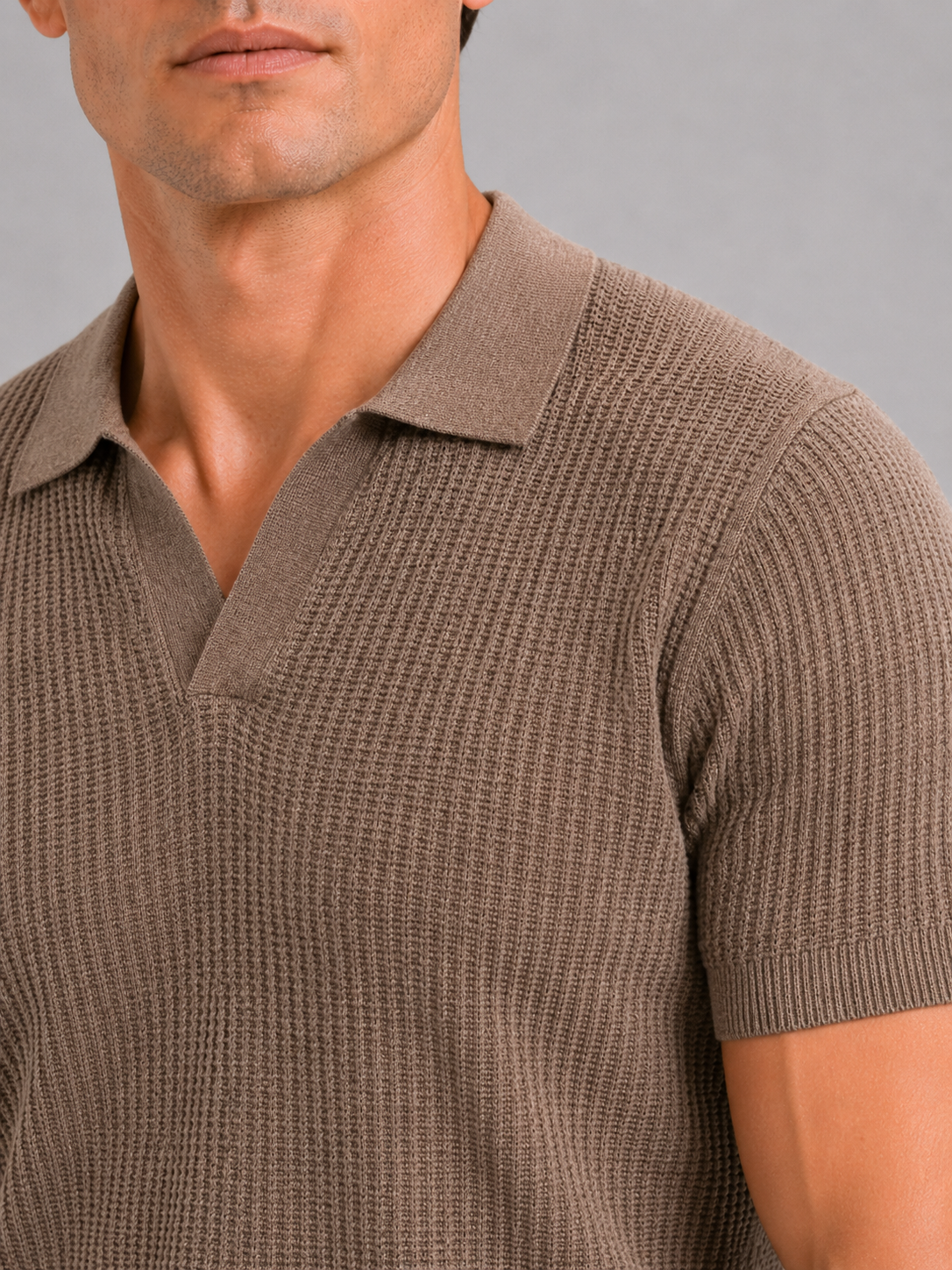 Close up of brown knit polo showing soft breathable fabric and refined collar detail